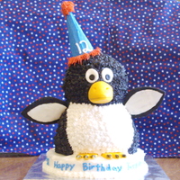 The Penguin Cake This started out as a bear. I used the Wilton stand-up bear pan, but carved off the unnecessary parts. After adding frosting and details...