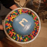 M & M Birthday Cake This is a birthday cake I did for my stepdad, he loves m&m's so it was perfect. I just pretty much did a big circle cake and cut...
