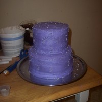 Purple Princess Cake This is a buttercream frosted princess style cake, it has edible pearl beads and edible silver beads, along with purple shimmer