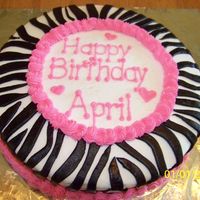 Zebra Cake With Hot Pink Round Lemon Cake, Butter cream Icing, With Hot Pink Buttercream Icing for piping and words, and black Fondant cut out to form zebra pattern...