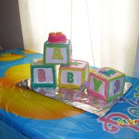 101_2034.jpg I made this cake for friends baby shower. Each block is a double layer yellow cake with butter cream icing and piped accents. I was very...
