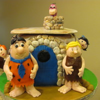 Meet The Flintstones This is my version of "Meeting the Flintstones" The figures are sculpted out of gumpaste and the house is covered in fondant.
