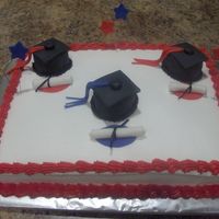 Graduation Cake This cake was for 3 graduates. Cake covered in buttercream w/ fondant accents!