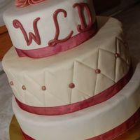 Burgundy & Ivory Cake 6", 8" & 10" rounds. Hand quilting on middle layer w/fondant burgundy/gold beads. Fondant roses and letters.