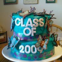 Niece's Butterfly Graduation Cake My first cake. Cake is iced in buttercream Had a few issues due to heat and buttercream not crusting. Top tier is a chiffon cake with a...