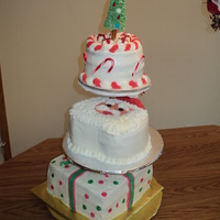 3 Tier Christmas Bottom cake chocolate w/ marshmello filling, middle cake wasc w/ rasbery filling, top cake red velvet w/ chocolate fudge filling.