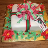 Christmas Present Carmel cake w/ Apple filling. Covered w/mmf. Bow and flowers mmf.
