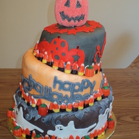 Topsy Turvy Halloween Cake Chocolate cake with strawberry filling covered with mmf. Designs done with cricut cake.