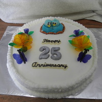 25Th Anniversary Cake yellow cake with buttercream icing. rolled buttercream lovebirds and lettering with gelatin flowers and gelatin butterflies. all edible....