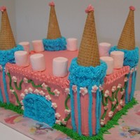 Castle Cake Strawberry flavored cake decorated in all buttercream with ice cream cones for the towers.