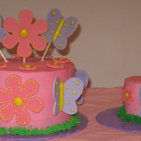 Pink Butterfly And Flower Cake Done in pink buttercream with gumpaste flowers and butterflies. For 1 year old's birthday.