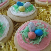 Easter Nest Cookies Soft sugar cookies (like Lofthouse) with coconut frosting, green coconut, and Whoppers Easter eggs.