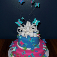 Butterfly Birthday 6 and 10 inch rounds covered in fondant with fondant bow butterflies and other decorations. Royal icing details on butterflies.