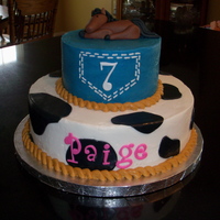 Cowgirl 7Th Birthday 6 inch top and 10 inch bottom both in butter cream with fondant cow print, "7" and horse on top.