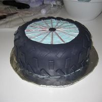 Bike Wheel Cake Bike wheel cake for my dad's birthday. Chocolate cake with black fondant. I then cut out a circle of fondant, exposing the blue...