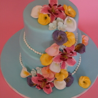 Cascade Of Sugar Flowers The flowers include stargazer lily, plumeria and calla lilies
