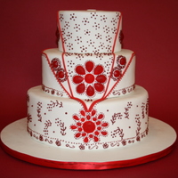 Red Jeweled Indian Style Wedding Cake Piping done in toyal icing. Red jewels made from Isomalt.
