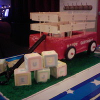 Wagon & Toys this was a challenge but came out GREAT! blocks r krispees with gumpaste/fond covering, wagon was 2 stacked cakes carved out with red fond...