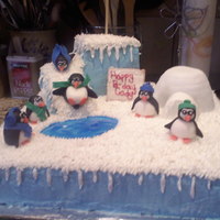 Winter Wonderland/penguins Playing water is colored pipe gel, penguins are made from fondant same with hats scarfs etc all fondant. first time i made a figurine.