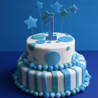 Simple Birthday Cake A simple birthday cake with a 1 year old. Circle, stripes and stars in blue/green fondant.