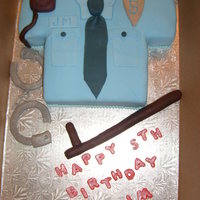 Police Shirt Cake Made for a 5 yr old boy who wants to be a police man. Vanilla cake with vanilla BC and MMF fondant. All accessories are made from fondant...
