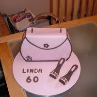 008.jpg First attempt at handbag cake and flowerpaste shoes. Not bad but the handle on the bag was a nightmare.Chocolate cake with chocolate BC .