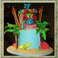 Luau Tiki Cake Bottom 9 inch cake consist of 8 layers of Pink Velvet cake with buttercream filling. Tiki 6 inch cake consist of 8 layers of Chocolate...