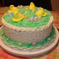 Dsc01080.jpg 2 layer 10" coconut cake with pineapple filling with buttercream basketweave on the sides and colored coconut on the top