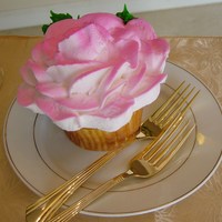 A Rose Is A Rose (Jumbo Rose Cupcake) A jumbo sized cupcake, decorated with a very large butter cream rose. To finish it off I airbrushed pink to the petals.