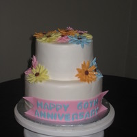 Daisy Cake This was for a 60th anniversary party. I was told that daisies were the wife's favorite flower, and they wanted a simple cake.