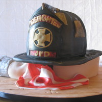 Fire Fighter Helmet On Coiled Hose This cake was a surprise for a groom who is a fire fighter. It was to resemble the grooms actual helmet. It was on a "coiled"...