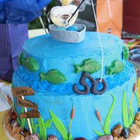Fishing 50Th Birthday Cake Fishing cake for a 50th birthday guy who likes fishing and Harleys. Cake w/buttercream icing. Fisherman, boat and grass are fondant. Fish...
