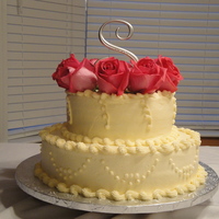Anniversary Cake Made this cake for an Anniversary. Real flowers, White Cake with Buttercream. Topped it with a Monogram Letter.