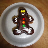 Mini Gingerbread Men Cakes Mini gingerbread man cake covered in melted dark chocolate and decorated with candy & royal icing.