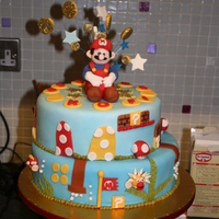Super Mario Cake my sons fith birthday cake, he wanted a super mario cake, and kept suggesting more and more things to go on it lol! Loved making it though...