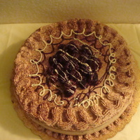 Bizcocho Suizo all cake is cover with chocolate whip cream and the top with blackberries and chocolate