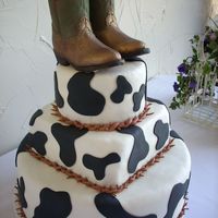 Cowhide With Boot This was a grooms cake i did this last weekend. the boots are made out of milk chocolate and i dusted them with luster dust to give them...