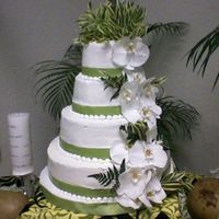 My First Wedding Cake Here is a picture of my very first wedding cake ever created. It is a four tier cake frosted in buttercream. The flowers and foliage are...