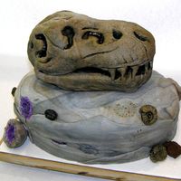 T-Rex Fossil And Friends The base "rock" is fondant covered pound cake. The T-rex is fondant covered RKT. The geodes are filled with purple suger...