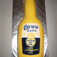 Corona Bottle This cake is make of vanilla cake, shaped to form with bc. label is fondant but with bc writing (free-hand). i was pretty proud of my label...