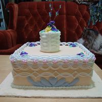 Final Cake For My Intermediate Cake Decorating Course Dummy cake covered in fondant, with royal icing string work, basket, and flowers. This was not my design, everyone in the class left with...