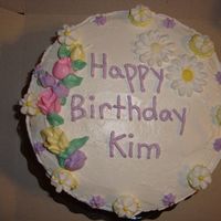 My First Cake Vanilla cake with lemon butter cream filling, royal icing daisies & drop flowers. My first cake after completing my beginner cake...
