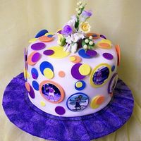 Hula Hoop Retiree This is a 3-layer cake for a lady who is retiring. There are edible images around the cake of her doing the hula hoop. The dots are gum...