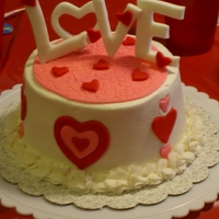 Love Small 6 inch I made for a Valentine's Day Party. Fondant decorations, buttercream icing and border. TFL