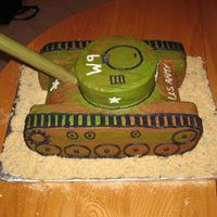 Army Tank Cake Chocolate and Chocolate Chip cakes with vanilla and chocolate buttercream icing. The 'gun' is a cardboard roll covered in...
