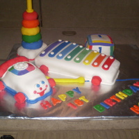 Classic Toys Birthday Cake This cake was made of 3 separate cakes with the block being the smash cake. The ring tower was made of rice crispy treats