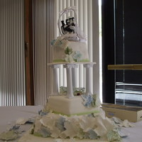 Maple Leaves Wedding Cake Cake has a spiral of sugarpaste maple leaves in the wedding colors (white, pale sage green and pale dusty blue) spiraling up the cake.