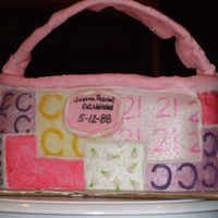Purse Cake For 21St Birthday Yellow cake frosted and filled with chocolate ganache. Covered in fondant and painted to look like a coach patchwork purse.