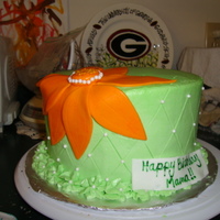 Orange Flower Cake for a birthday, one of my new favorites! Vanilla cake with vanilla buttercream. gumpaste flower and edible pearls.