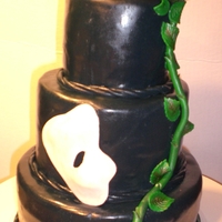 Phantom Of The Oprea Cake This is a Mini Cake 8", 6", 4" Fondant covered with gumpaste mask and rose.Red Velvet with Peanut Butter Mousse!